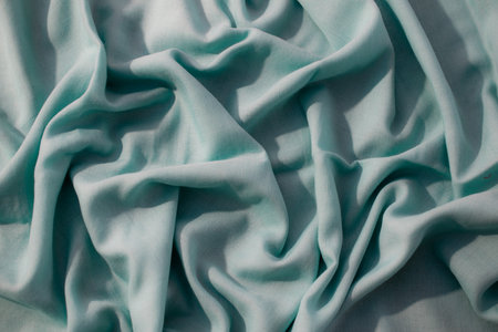 Nude green fabric wavy crumpled background texture with copy space.の写真素材