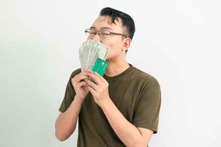 Happy asian man with money. Banking, Financial isolated, green color concept.