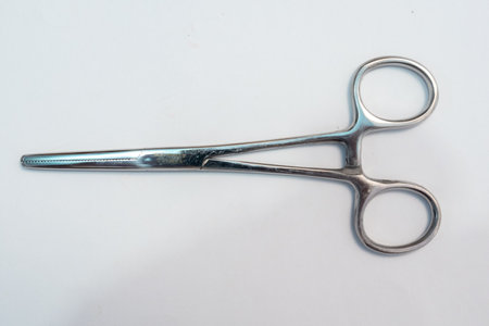 Isolated Surgical Forceps or clamp on white backgorund. Medical instrument