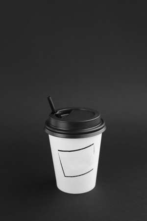 Kraft white cup for hot beverage on black background.の写真素材