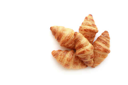 Five freshly baked tasty crusty croissants isolated on white.の写真素材