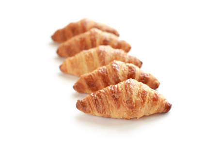 Five freshly baked tasty crusty croissants isolated on white.の写真素材