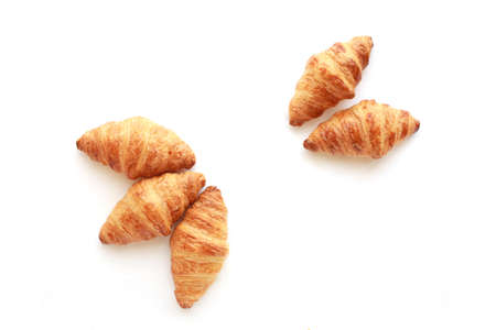Five freshly baked tasty crusty croissants isolated on white.の写真素材