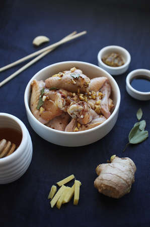 Chiken wings marinated with ginger, garlic, mustard, soya sauce and honey. Asian food.の写真素材