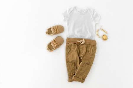 Mockup of white baby bodysuit shirt . Pregnancy announcement background with blurred . Selective focusの写真素材