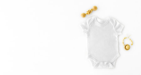 Mockup of white baby bodysuit shirt . Pregnancy announcement background with blurred . Selective...