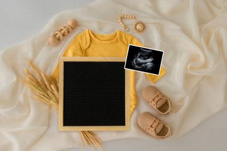 Baby Clothing Mock Up . Letterboard Baby Announcement. Space for design . Pregnancy announcement background with blurred . Selective focusの写真素材