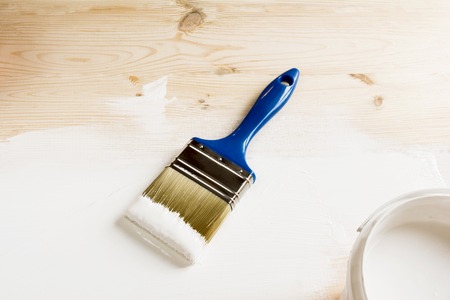 brush and white paint on wooden boardsの写真素材