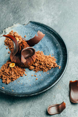close-up of chocolate brownie in black plate on gray concrete backgroundの写真素材