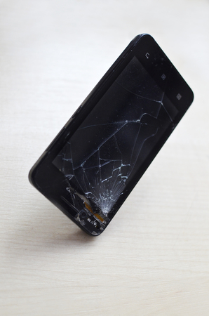 Broken screen cell phone on gray background.Smartphone Insurance and Mobile phone warranty concept. close-upの写真素材
