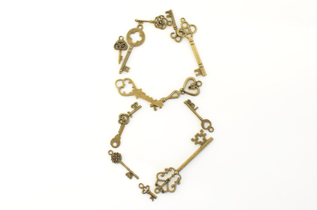 Decorative keys of different sizes, stylized antique on a white background. Form the centerpiece.の写真素材