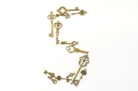 Decorative keys of different sizes, stylized antique on a white background. Form the centerpiece.の写真素材