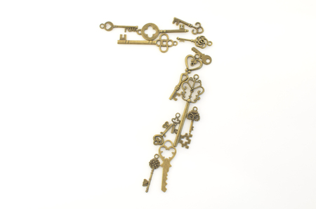 Decorative keys of different sizes, stylized antique on a white background. Form the centerpiece.の写真素材