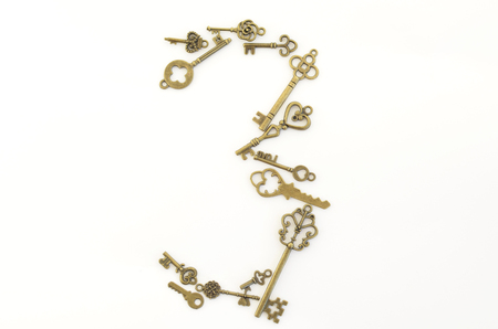 Decorative keys of different sizes, stylized antique on a white background. Form the centerpiece.の写真素材