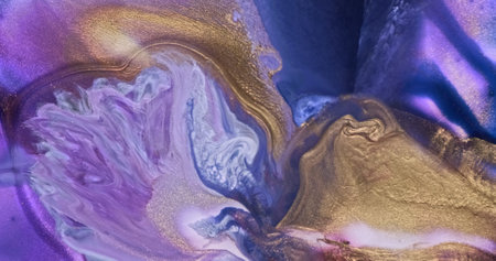 Lilac gold ink shiny splash current background. Beautiful abstract paint flow. Purple blue gold color fluid art mix. Golden glitter liquid in motion. Creative texture, patternの写真素材