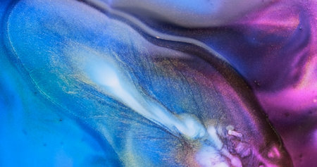 Blue purple liquid abstract background. Slow motion fluid art splash. Brilliant blue lilac paint spreads sparkling with glitter. Golden particles sparkle in colorful blue-purple watercolor backdropの写真素材