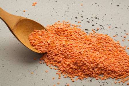 red lentils on a wooden spoonの写真素材