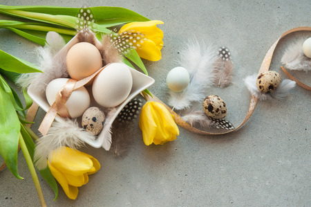Easter card with eggs, feathers and flowers