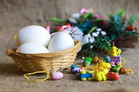 Easter eggs and small decorative eggs on brown sackcloth
