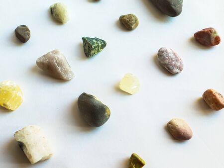 Collection of multi colored deferent stones on white backgroundの写真素材