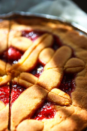Homemade pie with hamemade raspberries jam on the table on a white tablecloth.の写真素材