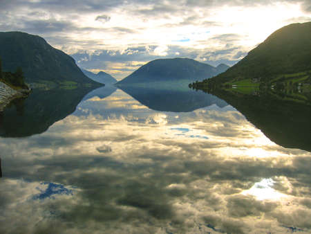 Norwegian fjords with clouds reflection in waterの写真素材