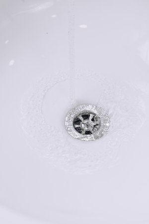 Water flows in white sink. High quality photoの写真素材