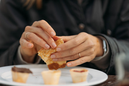 Woman hands holding crepe in cafe outdoors choosing topping in waffle cups. High quality photoの写真素材