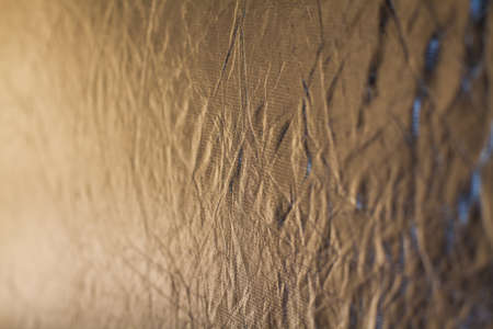 Photography reflector material in silver color, reflecting sunlight and a bit of sky.の写真素材