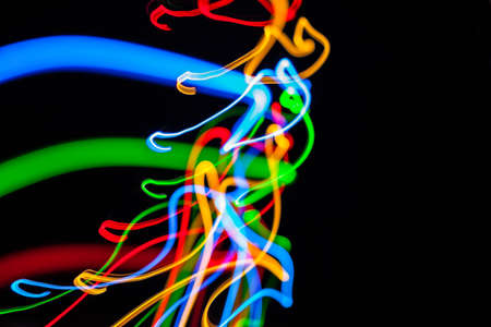 Colorful bright red, yellow, blue and green mixed Christmas lights flowing in various directions...