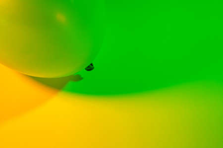 Simple abstract single air balloon color gradient background made by two colorful lights transitioning into each other. Green and yellow.の写真素材