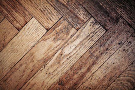 Old used scratched natural wooden parquet floor texture, top viewの写真素材