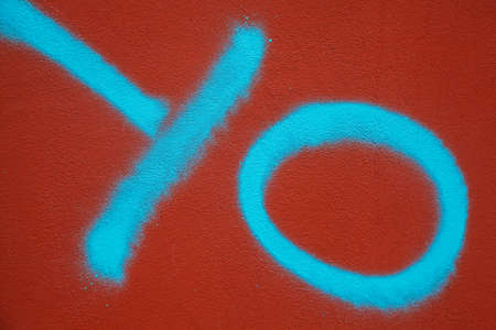 Spray painted turquoise letters on red wallの写真素材