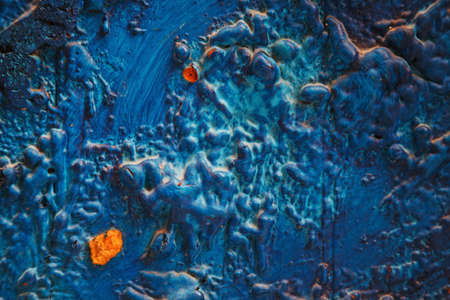 Bright turquoise blue painted textured surface made of construction foam on wood, creating various height and size elevations.の写真素材