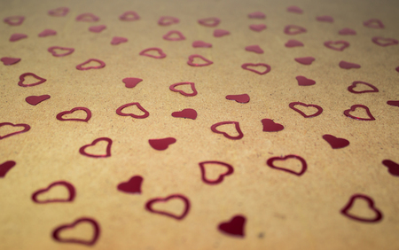 Red heart shaped confetti on wooden background. St. Valentine's Day concept, wallpaper or...