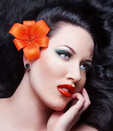 Beautiful Brunette Girl with flower. Healthy Long Hair.brunettの写真素材