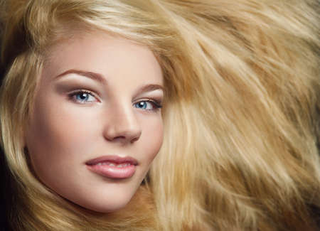 Close-up shot of young beautiful girl with long blond hair and stylish make-upの写真素材