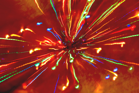 Abstract multicolored festive lights on a red and orange background.の写真素材