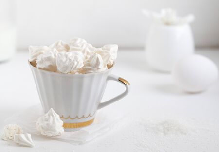 Meringues. Protein sugar cake for tea or coffee. Light background.White morning. Candyの写真素材
