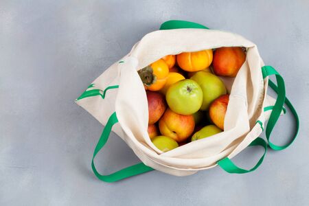 Fruits in reusable cotton textile white bag. Zero waste shopping, storage and recycling concept, eco...