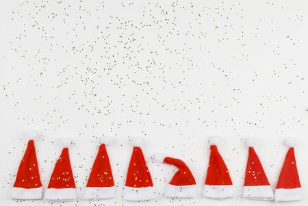 Santa Claus hats on white background with little stars. Christmas and New Year celebration. Christmas concept. Dissimilarity conceptの写真素材