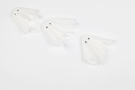 Top view of Halloween crafts, paper ghost on orange paper background with copy space for text. halloween concept.の写真素材