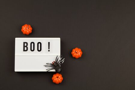 Lightbox with the text BOO. Flat lay of accessory decoration Halloween festival background concept. Top view close up copy pastの写真素材