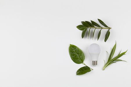 Light bulb with recycling symbol on white background . Concept of ecology and green energy. copy space top view.の写真素材
