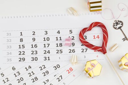Valentine's Day background. Date February 14 on calendar, Valentine's Day red heart circled. Flat lay, top view, copy spaceの写真素材