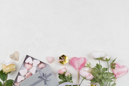 white and pink candy in form of hearts in box , flowers, decoration ,lollipop and ribbon. Valentines day background. love symbol, space for text concept. greeting cards, sale, bannerの写真素材