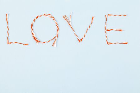 Valentines day composition with Love word and confetti on blue background. Flat lay, top view. design element for greeting cards, saleの写真素材