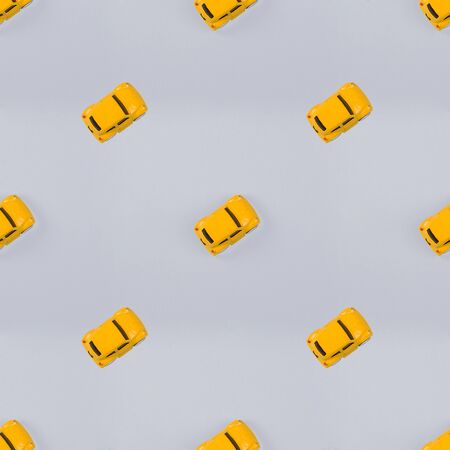 pattern with yellow cars on blue background. Flat lay, top view, view from above. Photographic collage and seamless patternの写真素材