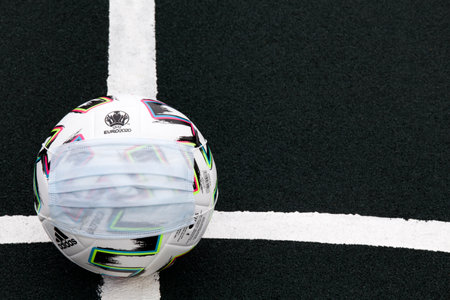 Soccer Ball with medical mask on field. Euro 2020 football tournament. close upのeditorial素材