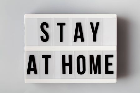light box with words stay at home, reduce risk of infection and spreading the virus. Save planet from corona virus. copy spaceの写真素材